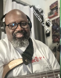 a picture of a man with headphones and a guitar